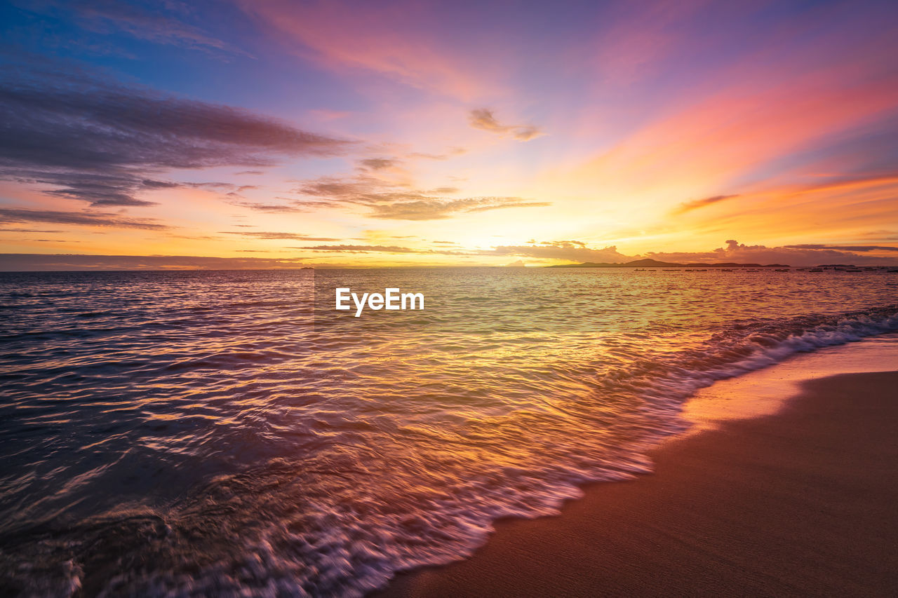 SCENIC VIEW OF SEA AGAINST ORANGE SKY