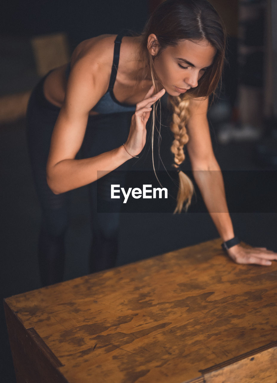 Young woman exercising in gym