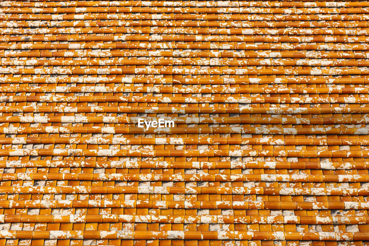Tile roof texture, background of red tiles with white spots