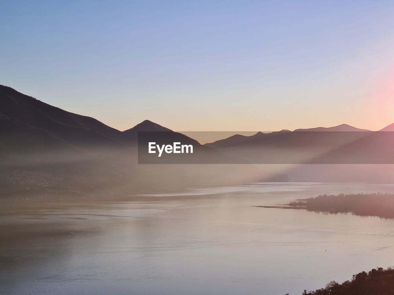 Scenic view of mountains against clear sky during sunset