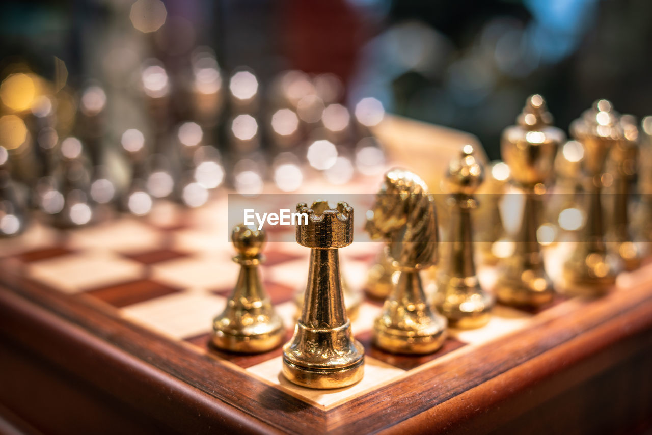 CLOSE-UP OF CHESS PIECES ON TABLE AT HOME