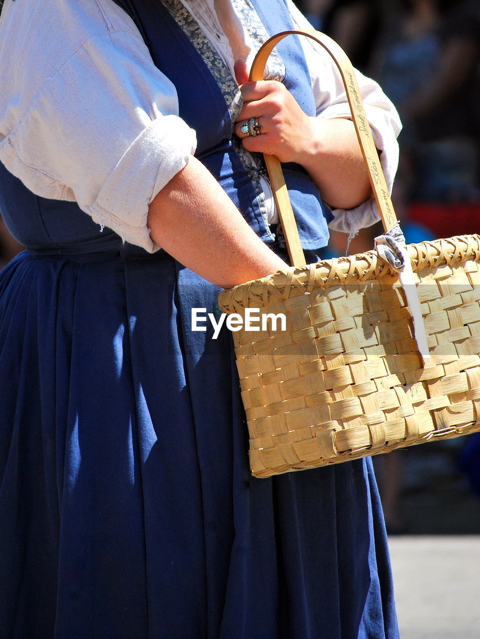 Midsection of woman holding basket