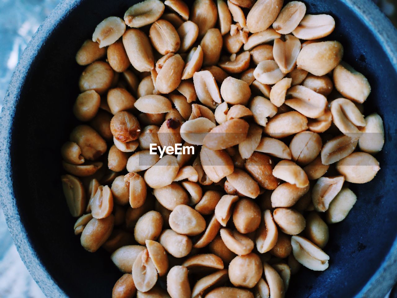 Overhead view of peanuts in bowl at table