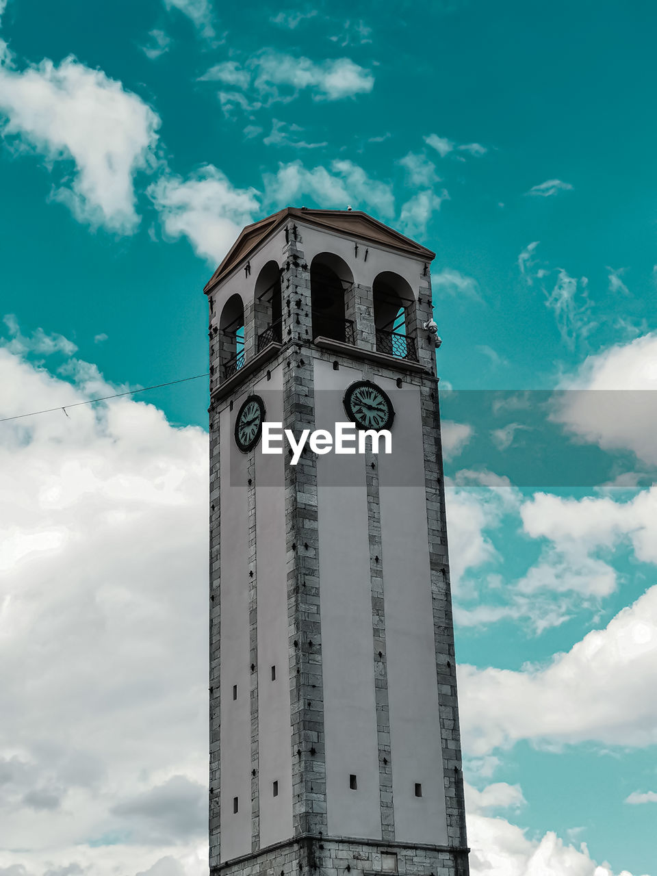 Low angle view of elbasan castle clock tower against cloudy sky