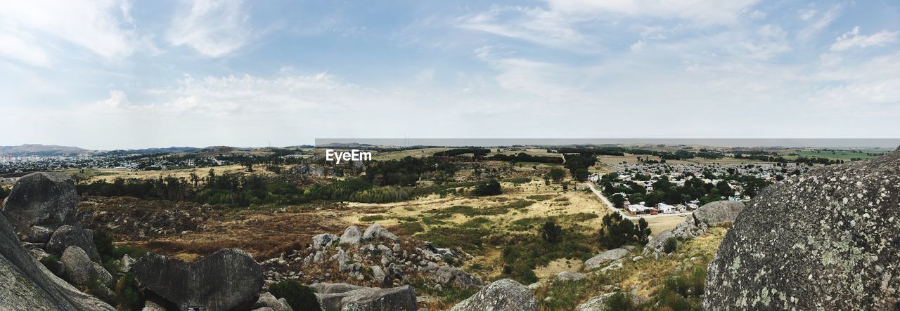 Panoramic view of agricultural landscape against sky