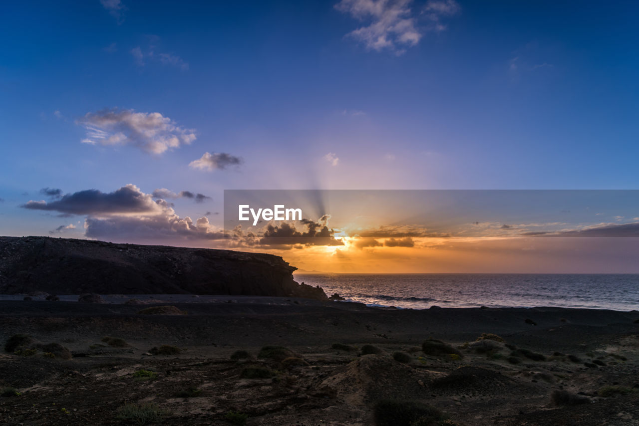 SCENIC VIEW OF BEACH DURING SUNSET