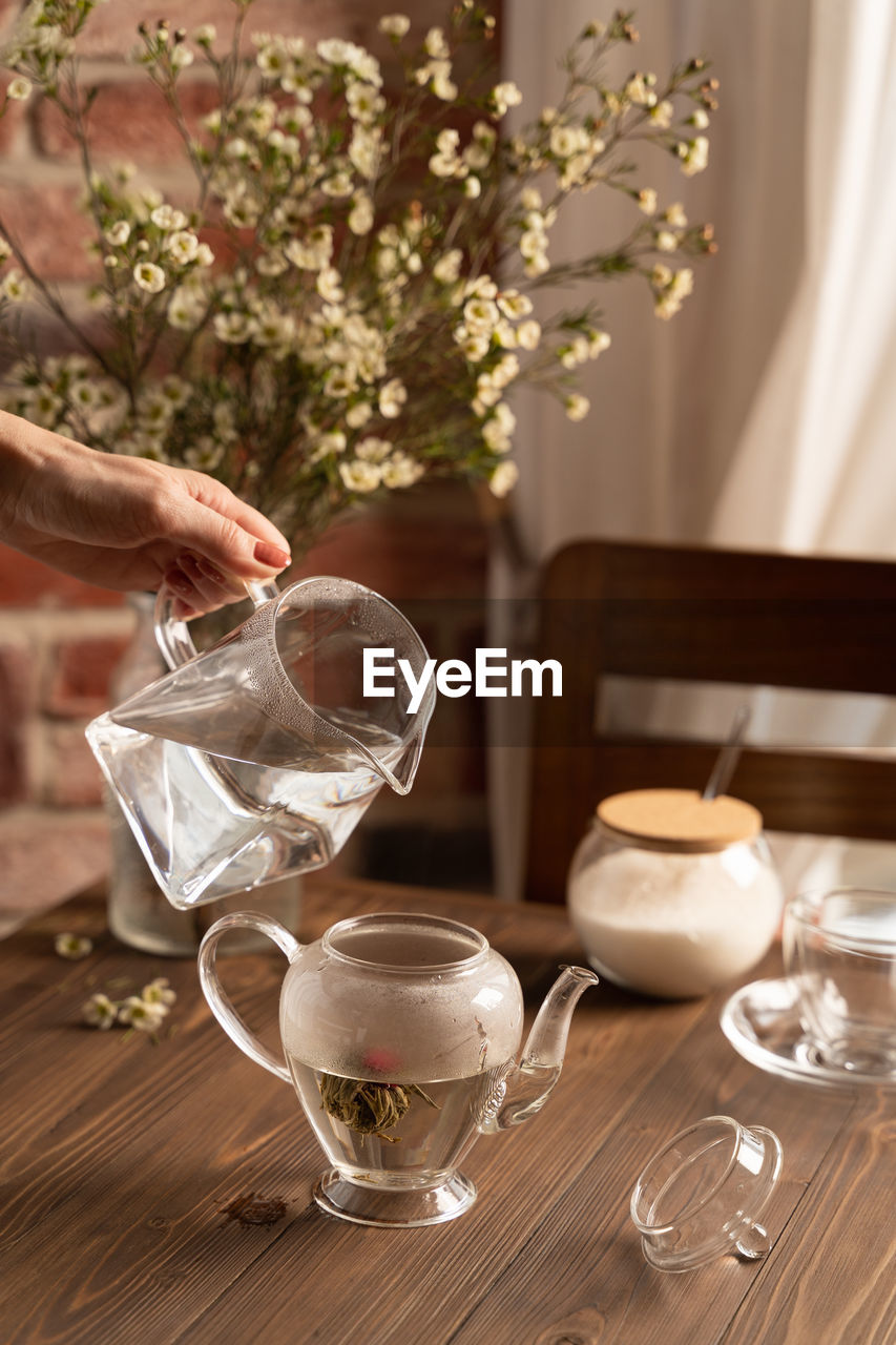 Brewing flower tea in a glass teapot lifestyle