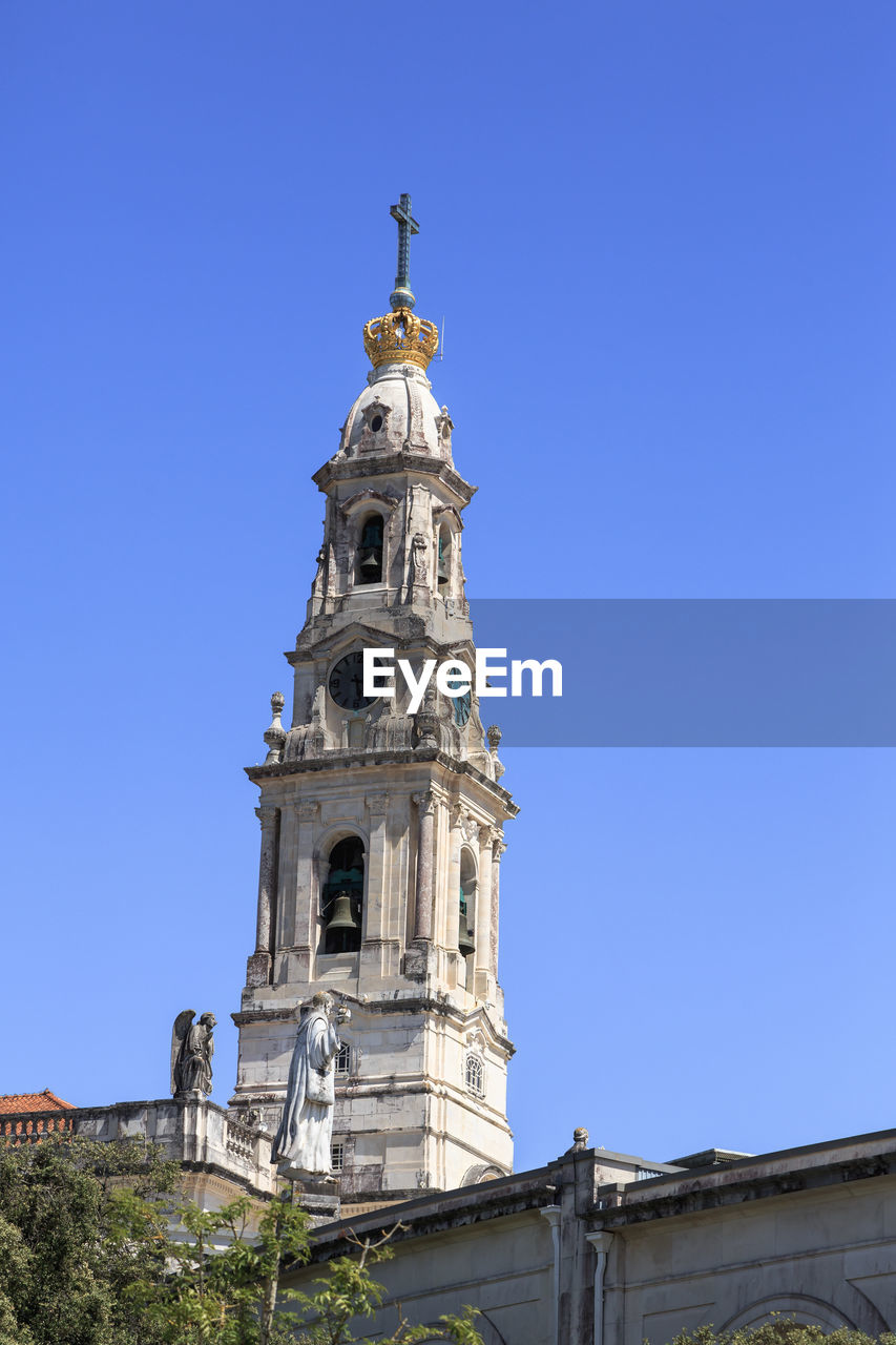 low angle view of church against clear blue sky