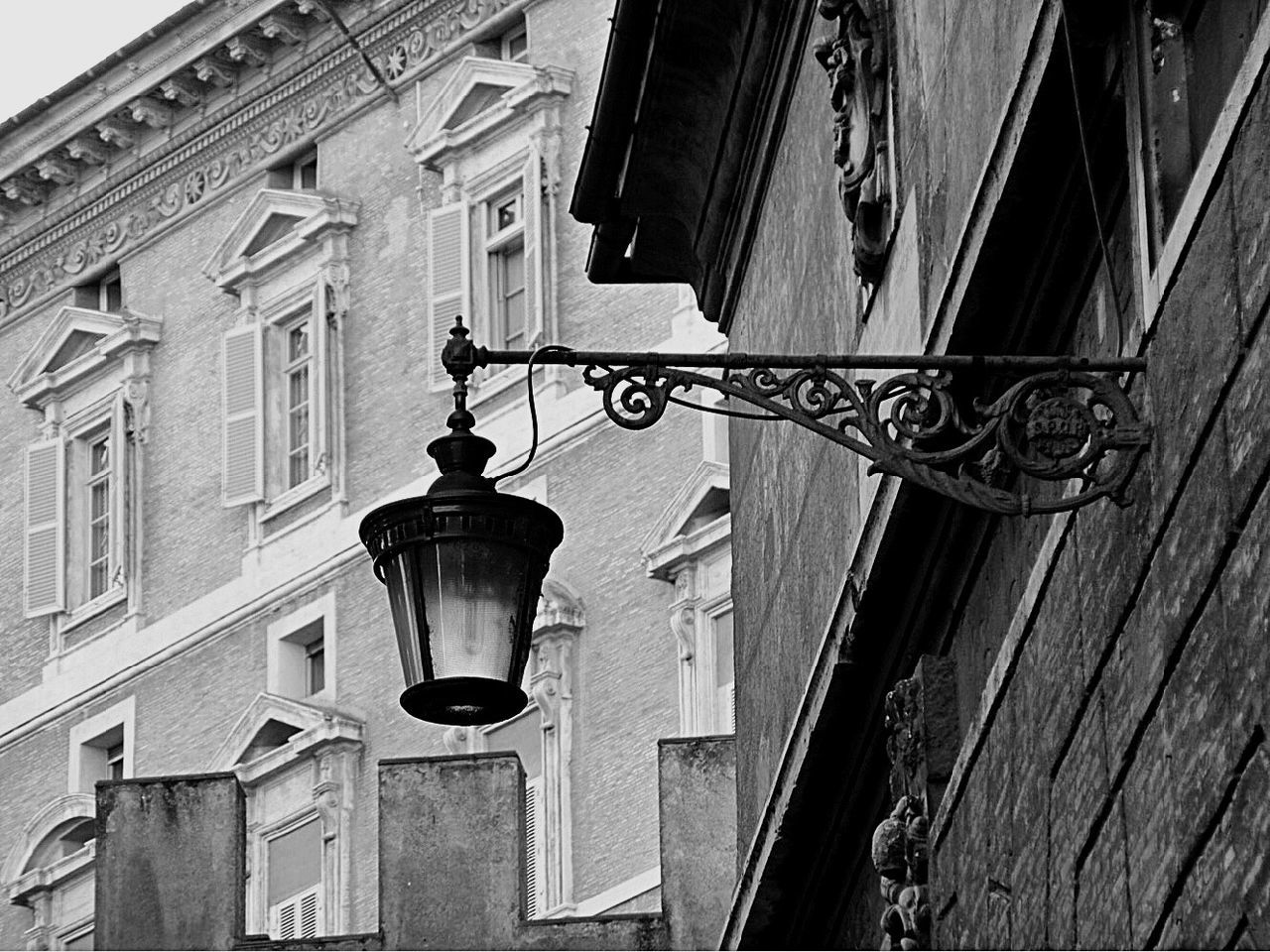 LOW ANGLE VIEW OF STREET LIGHT HANGING ON WINDOW