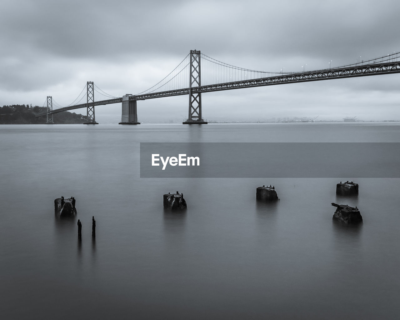 Low angle view of oakland bay bridge over sea against sky