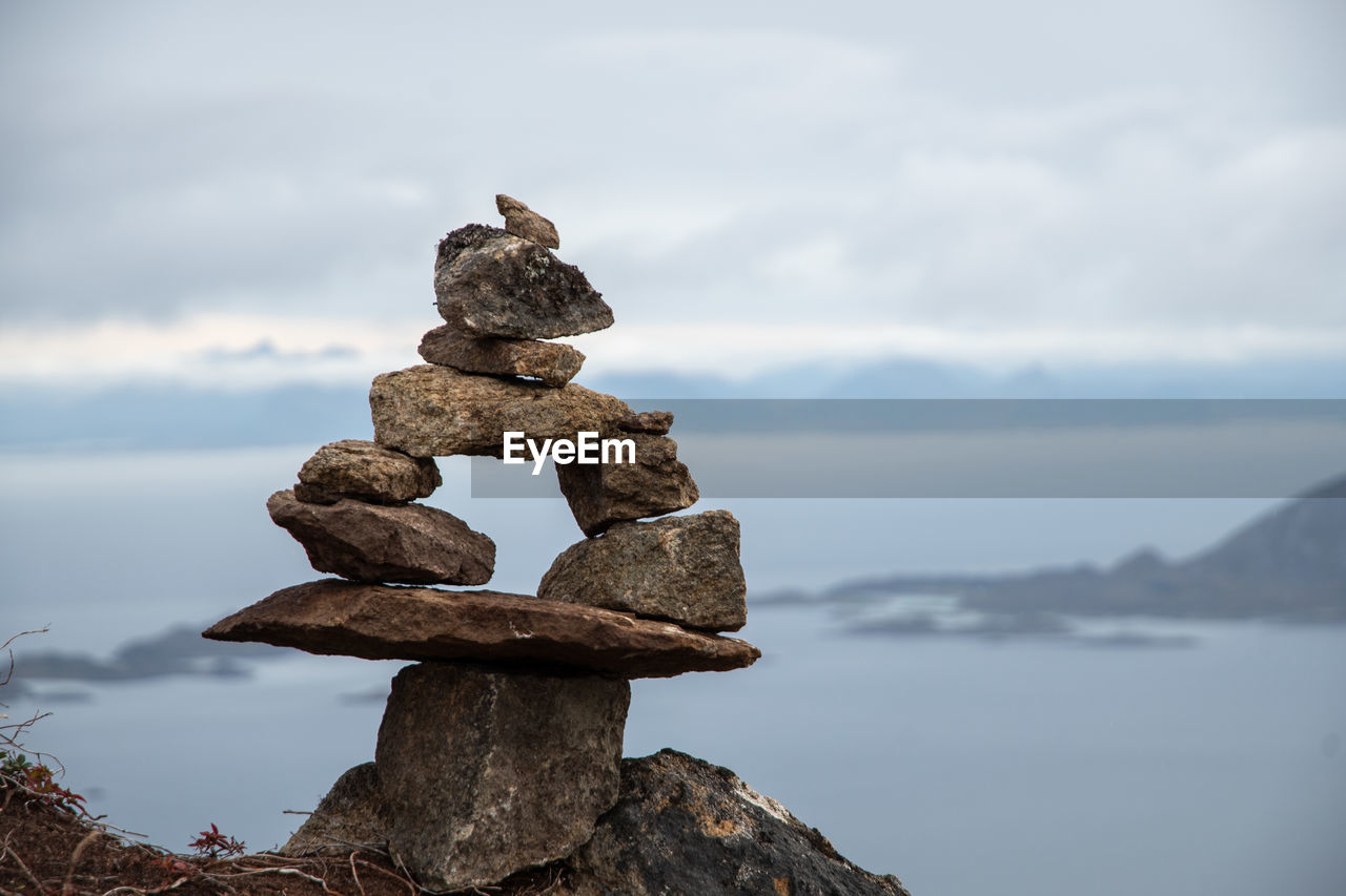 balance, rock, sky, nature, cloud, water, zen-like, tranquility, no people, statue, sea, reflection, sculpture, beauty in nature, stone, coast, tranquil scene, day, outdoors, scenics - nature, mountain, focus on foreground, land, temple, environment, beach, landscape, travel destinations