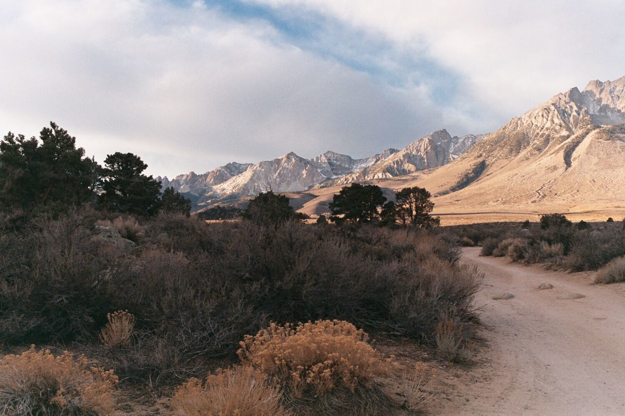 Mountain range against cloudy sky