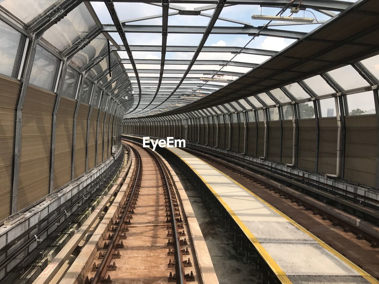 Empty railroad station platform during sunny day