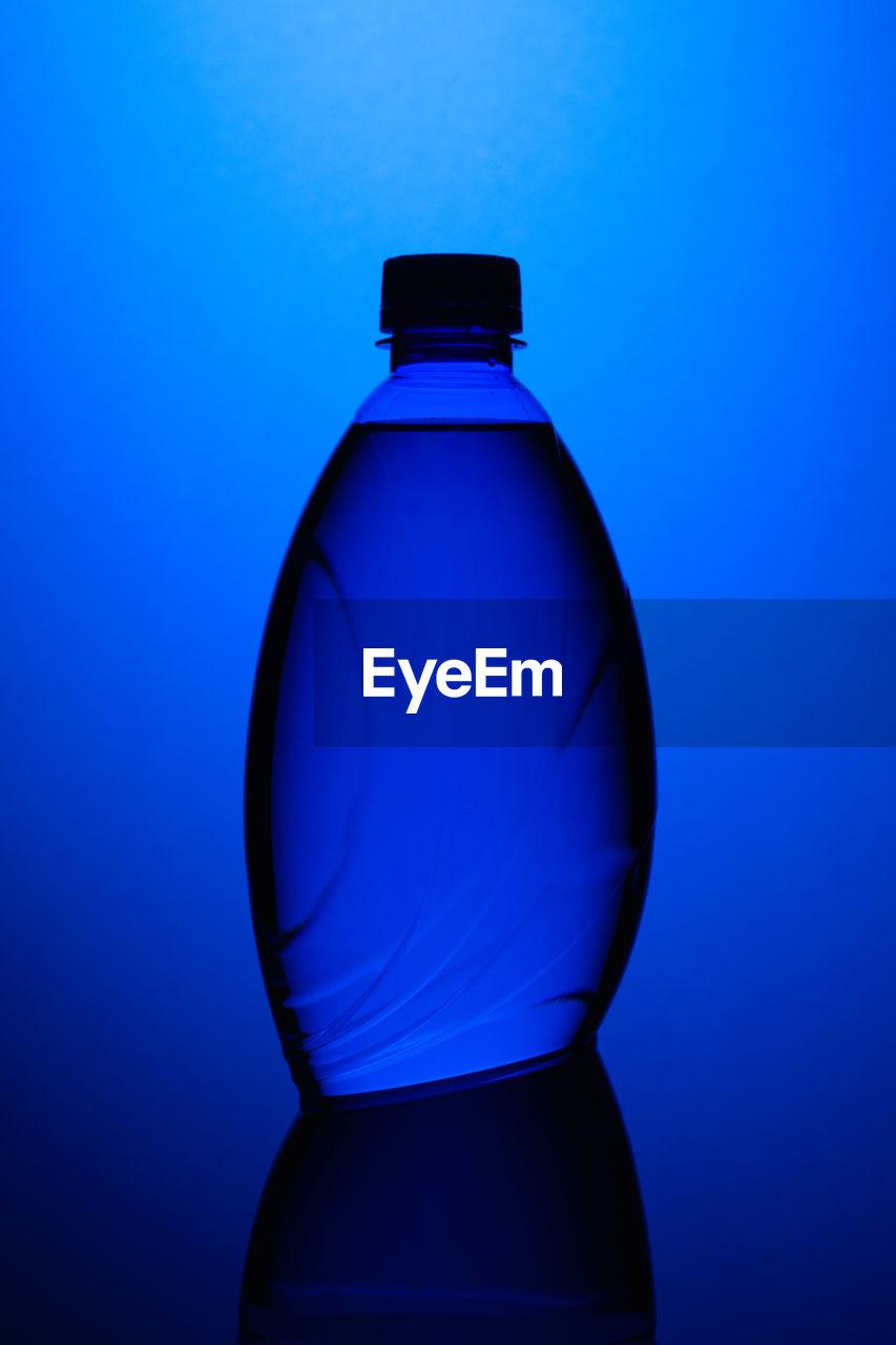 Close-up of water bottle in blue light