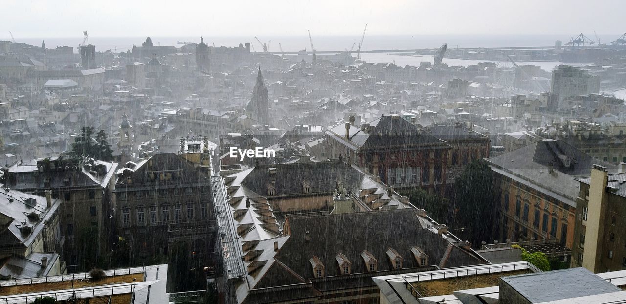 High angle view of buildings in city under the rain