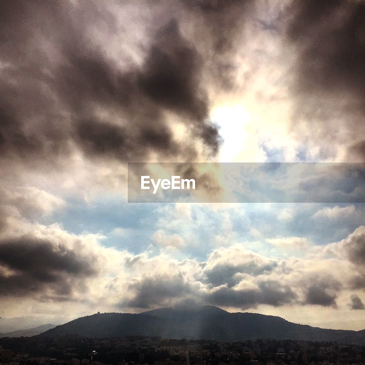 SCENIC VIEW OF MOUNTAINS AGAINST CLOUDY SKY