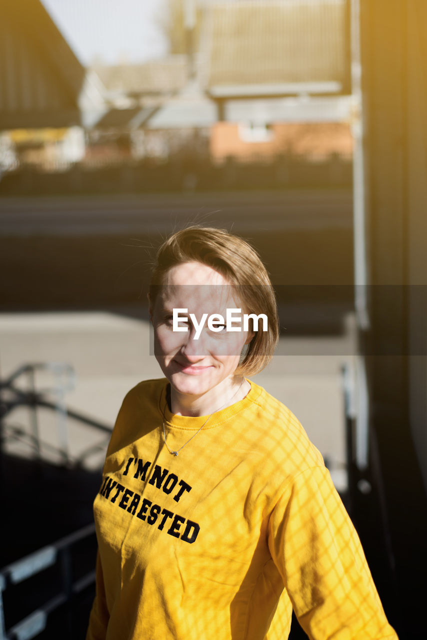 High angle portrait of smiling woman standing indoors