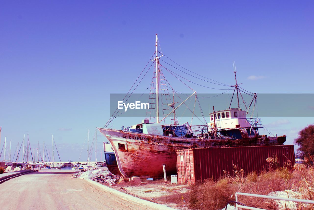 SHIP MOORED AT BEACH AGAINST CLEAR SKY