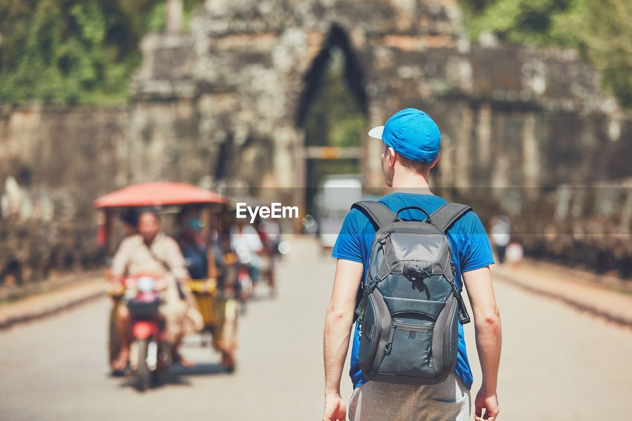 Rear view of backpacker on road