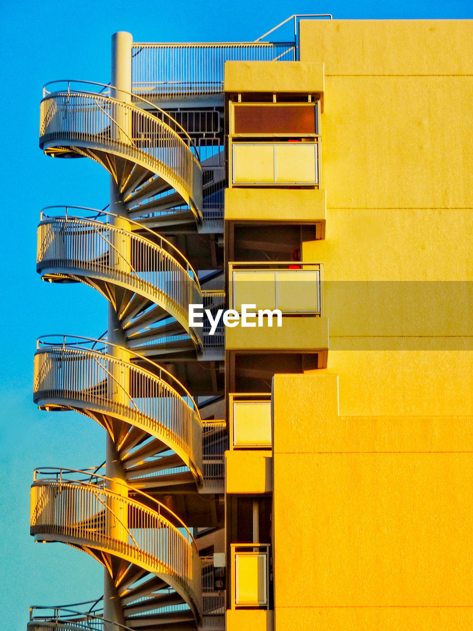 Low angle view of modern building against blue sky