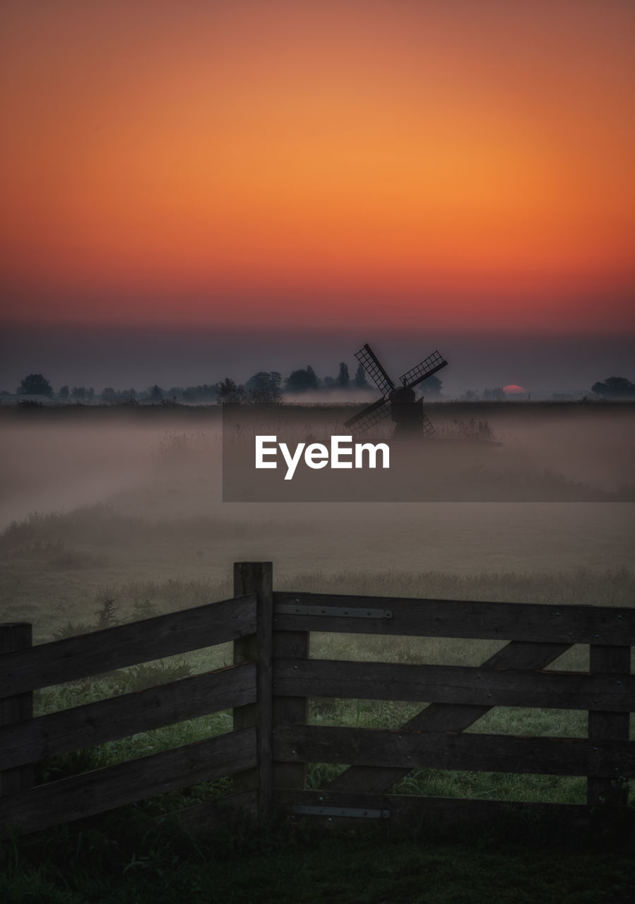 SCENIC VIEW OF SILHOUETTE FIELD DURING SUNSET