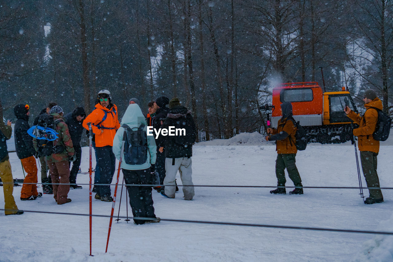 PEOPLE STANDING IN SNOW