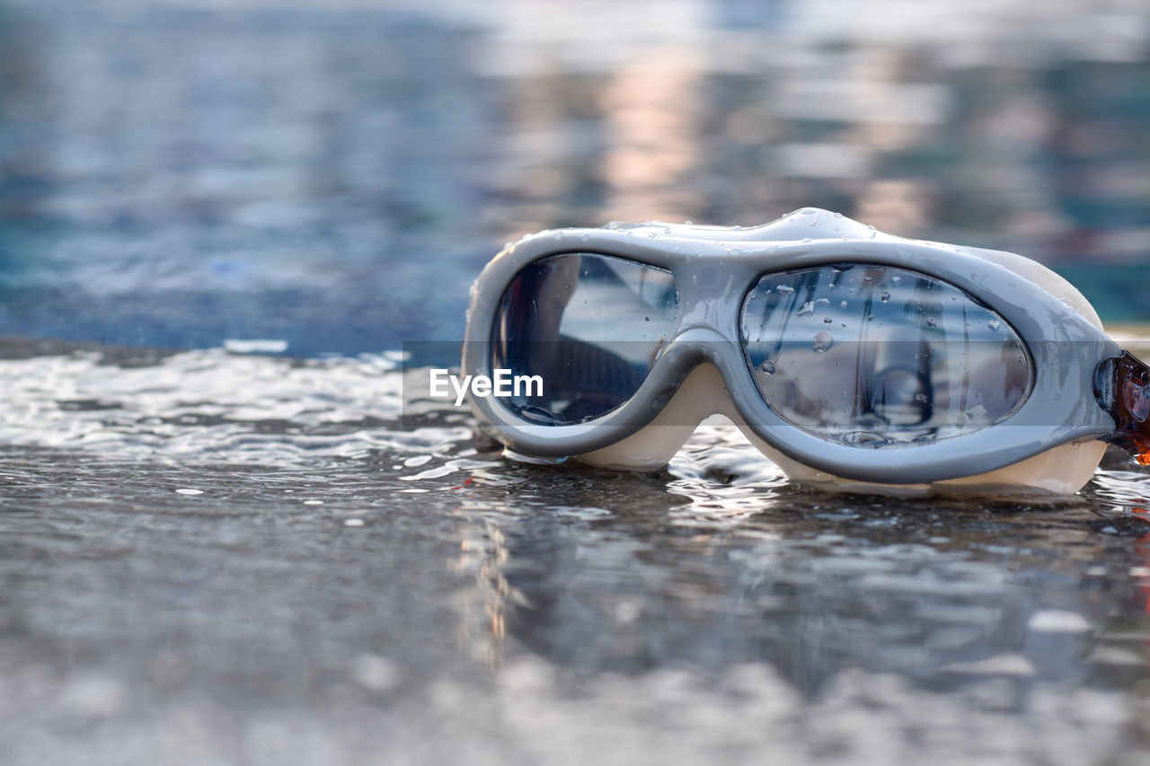 Close-up of goggles on swimming pool