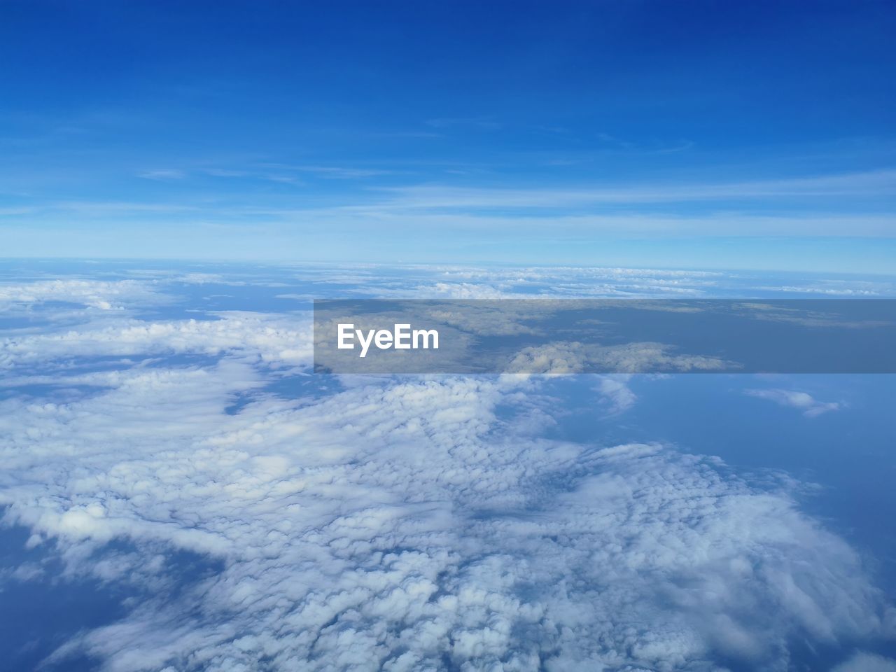 sky, cloud, aerial view, horizon, environment, blue, scenics - nature, beauty in nature, nature, cloudscape, landscape, no people, high up, white, mountain range, atmosphere, plain, tranquility, tranquil scene, idyllic, high angle view, airplane, outdoors, day, copy space, backgrounds, aerial photography, travel, fluffy, mountain, air vehicle, flying, planet earth, sunlight, urban skyline, space, above, cold temperature, winter