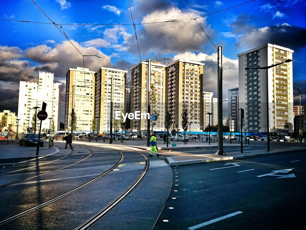 Railroad tracks by buildings in city