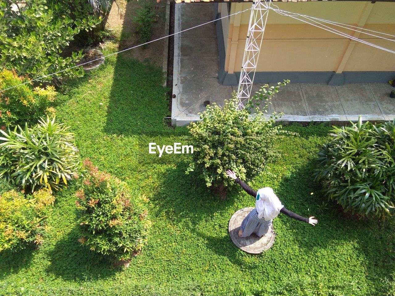 High angle view of woman standing on field in yard