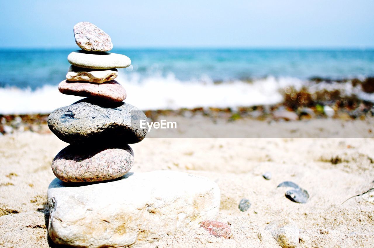 Scenic view of rocks stacked on beach