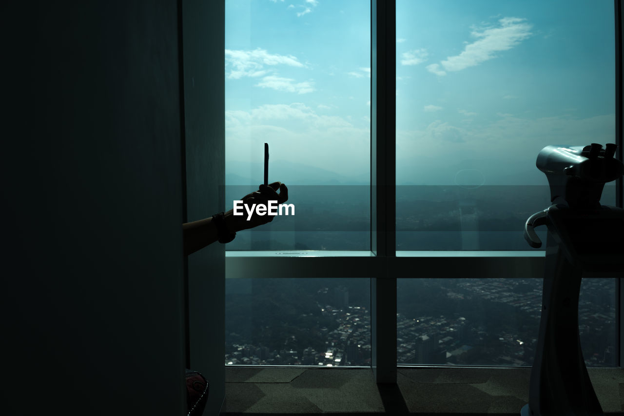 CLOSE-UP OF MAN AGAINST WINDOW