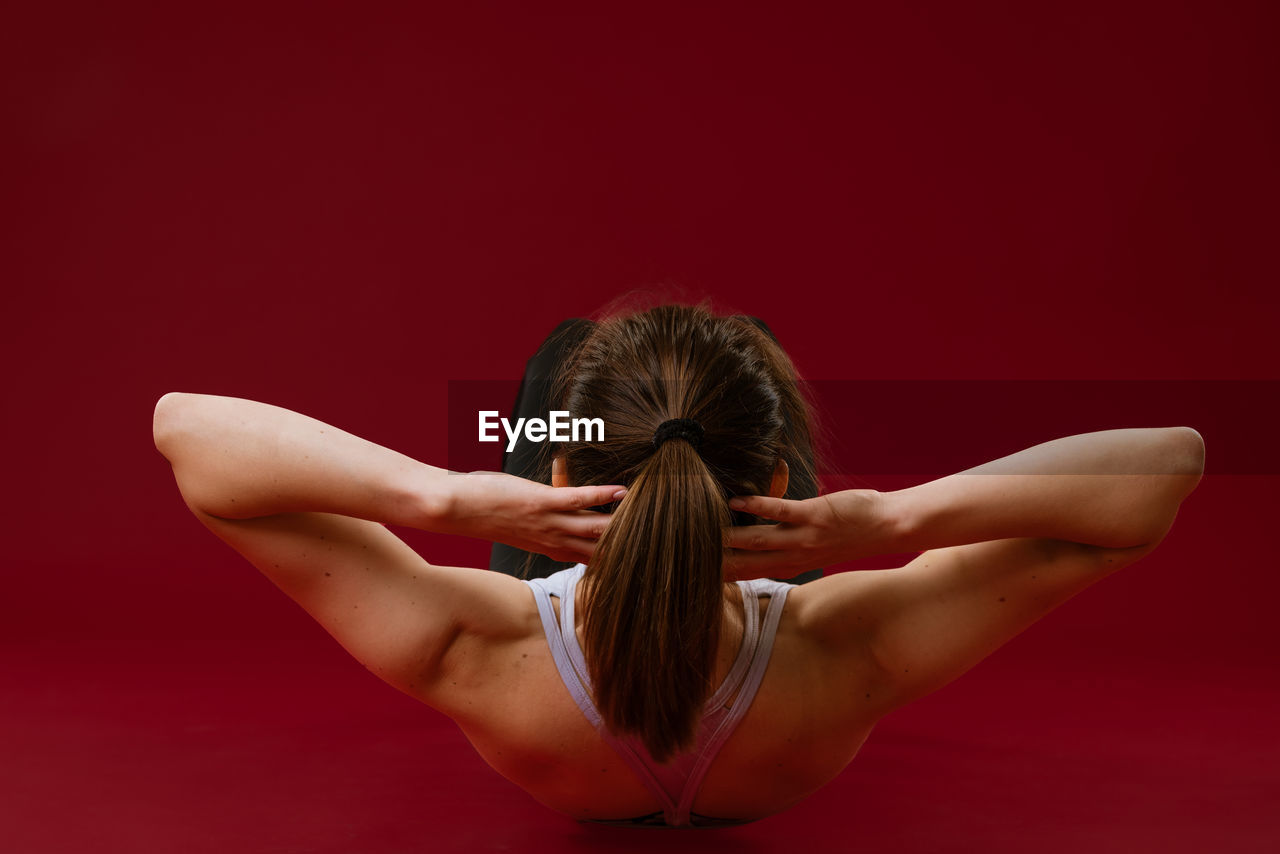 Woman goes in for sports on a red background