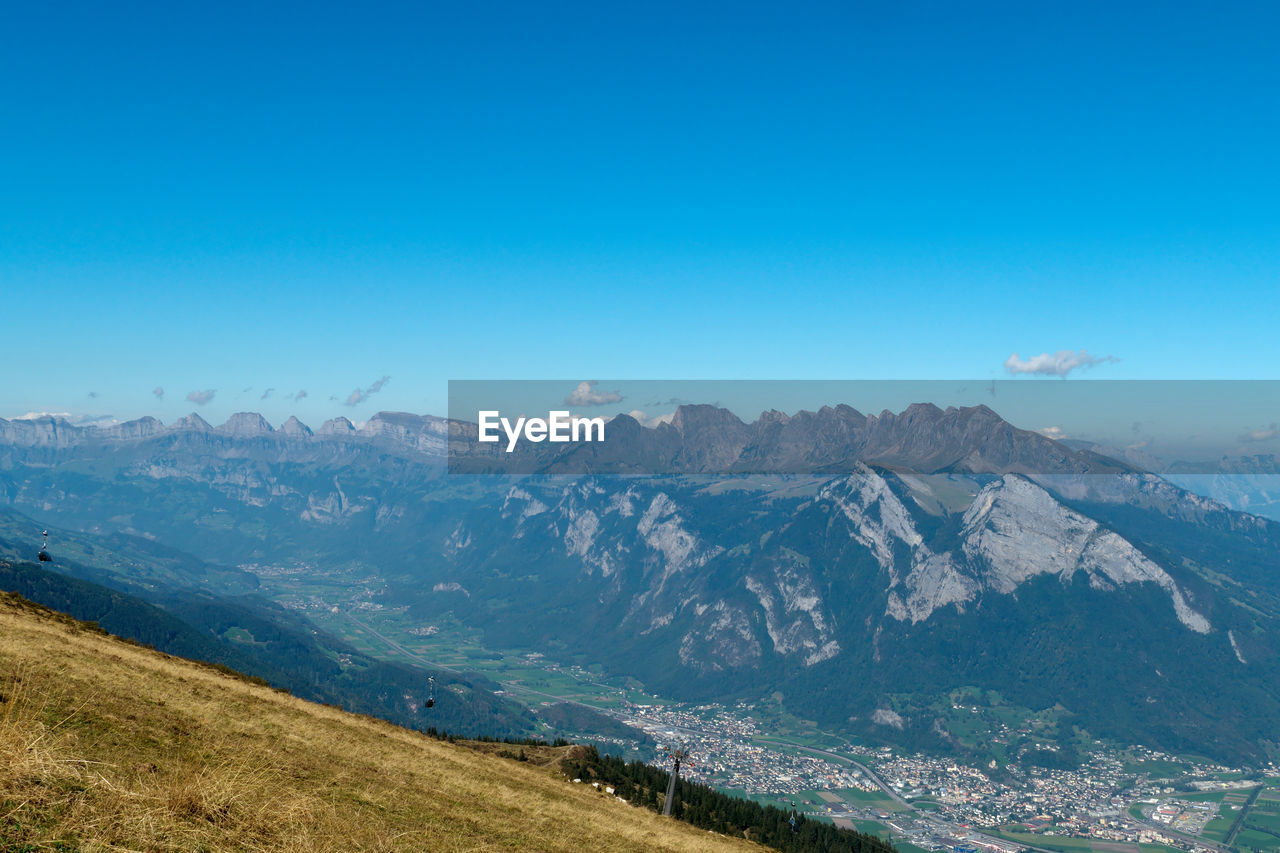 Scenic view of mountains against clear blue sky