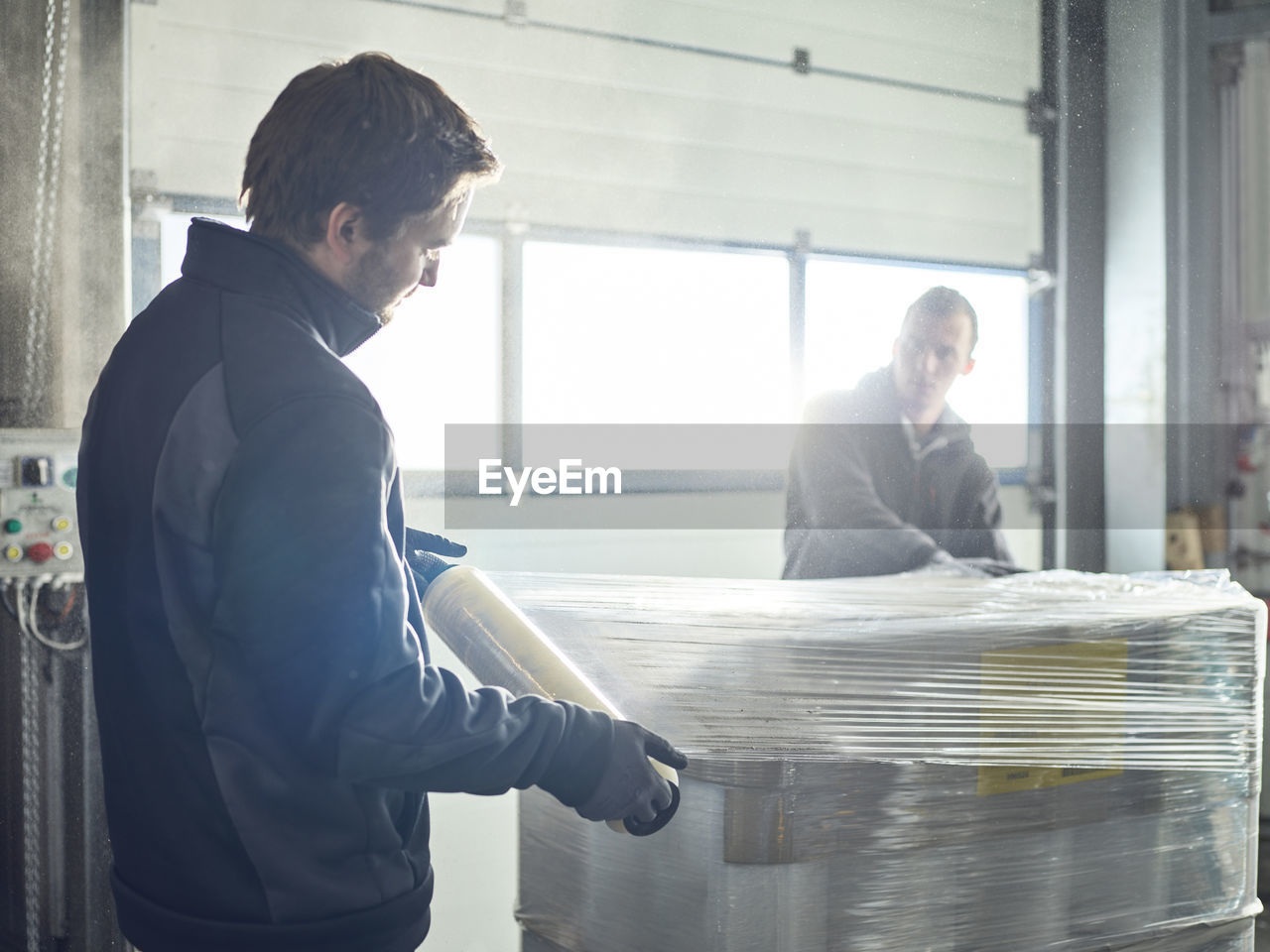 Workers closing freight with foil