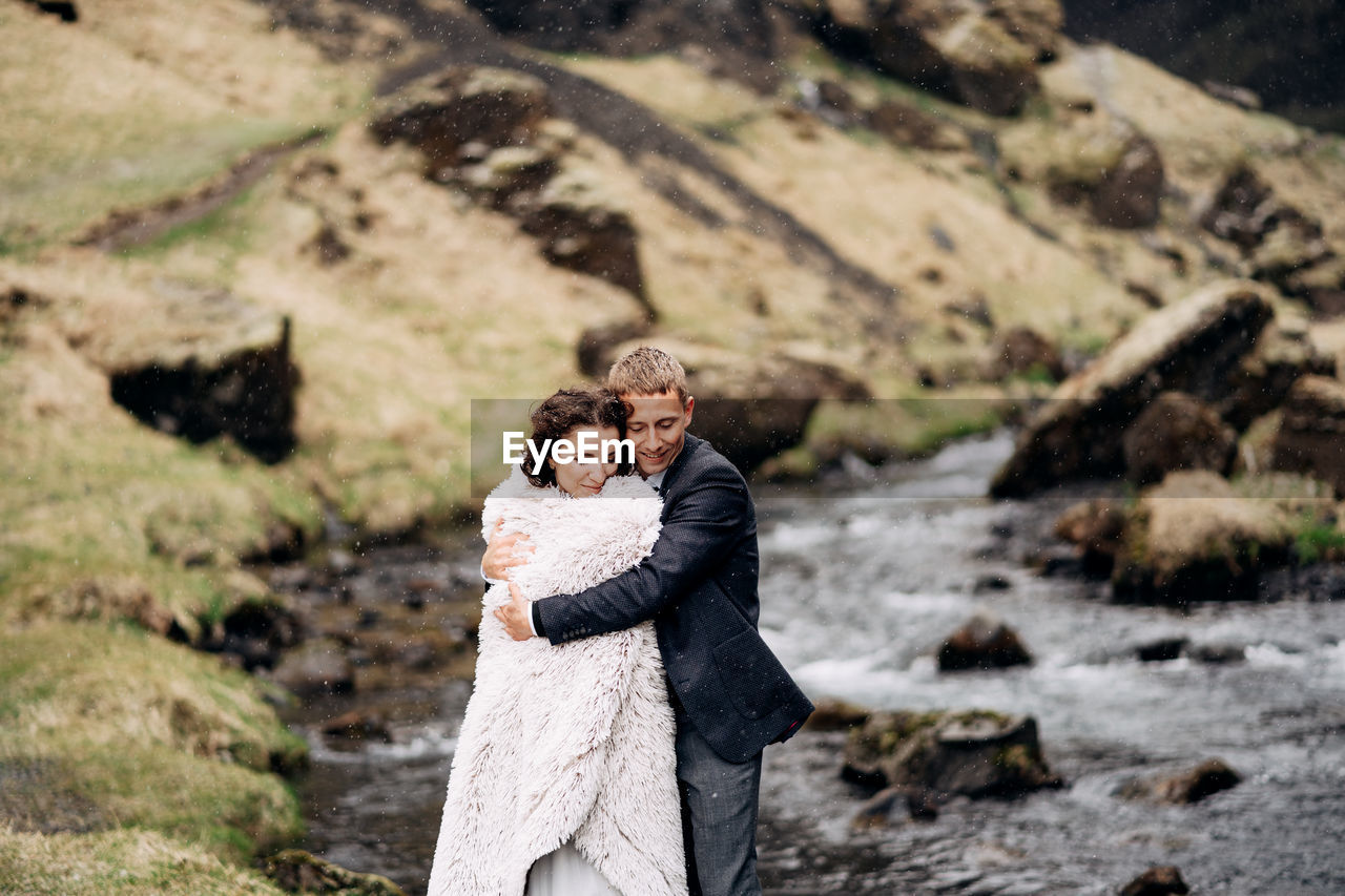 FULL LENGTH OF COUPLE ON ROCK