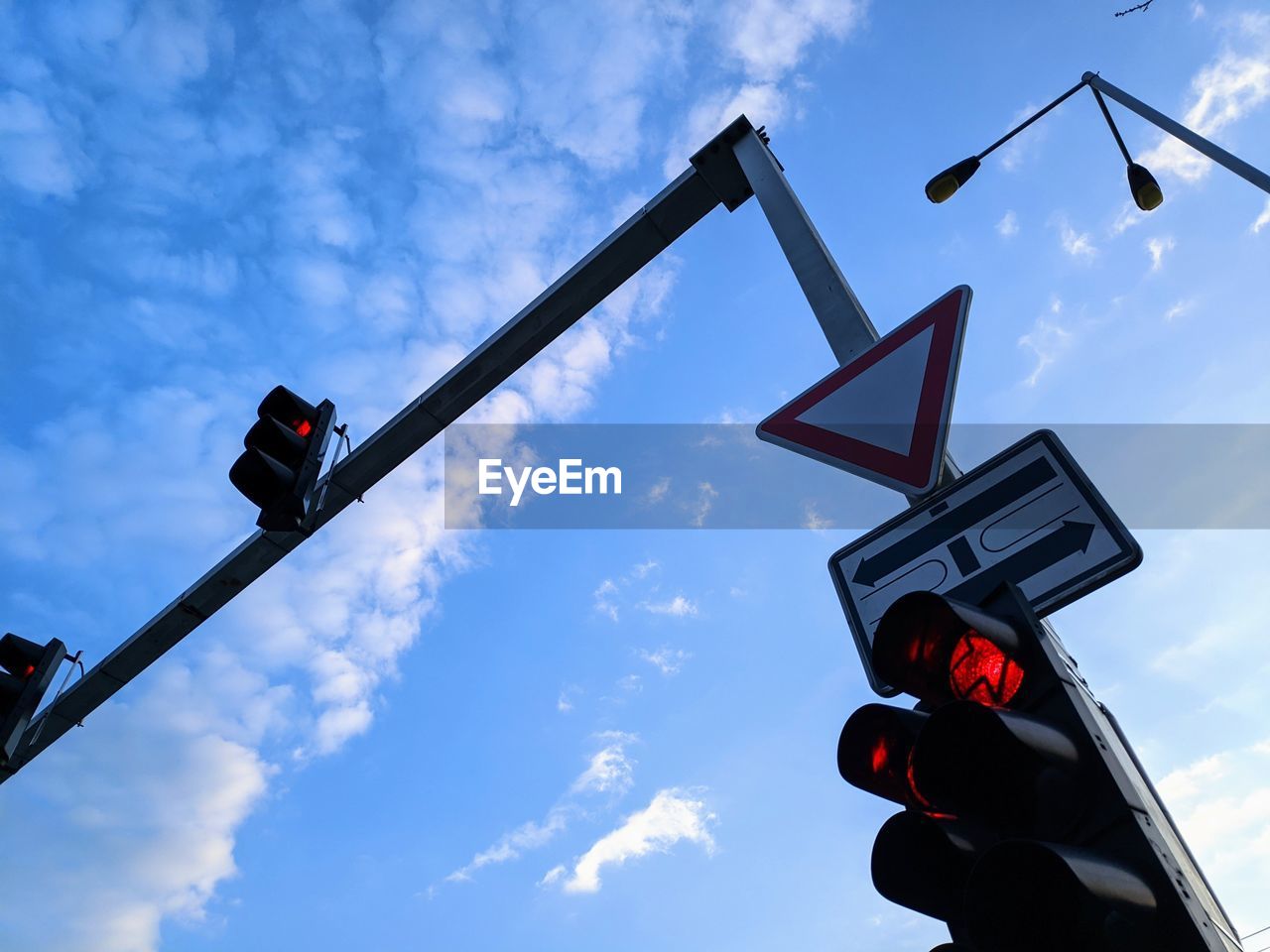 Low angle view of road signal against sky