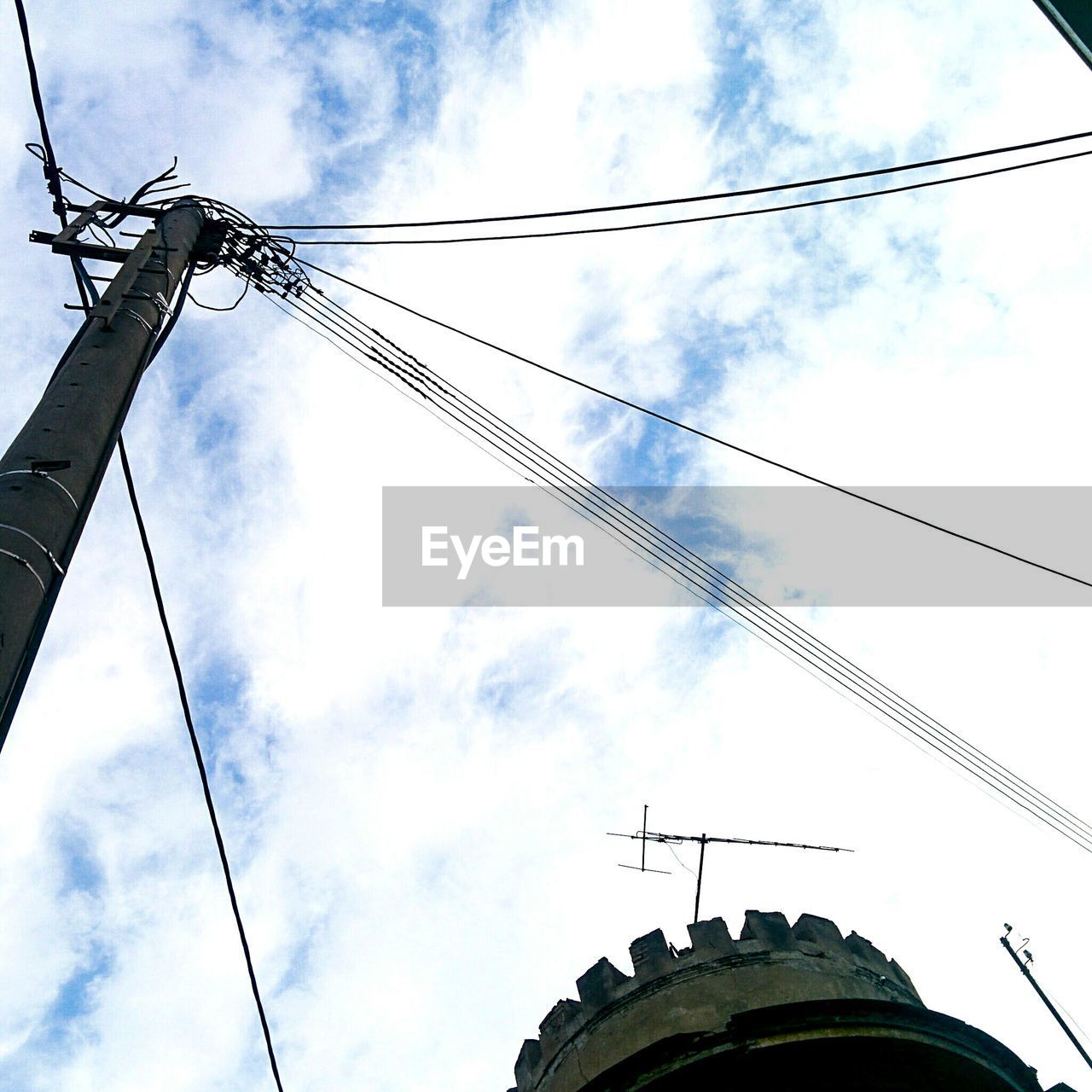 Low angle view of electricity pylon against sky