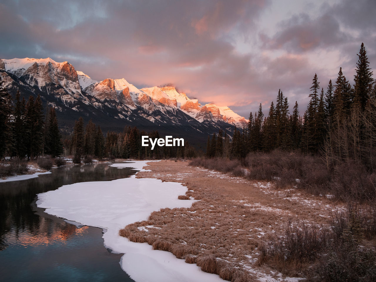 Scenic view of snowcapped mountains against sky during sunset