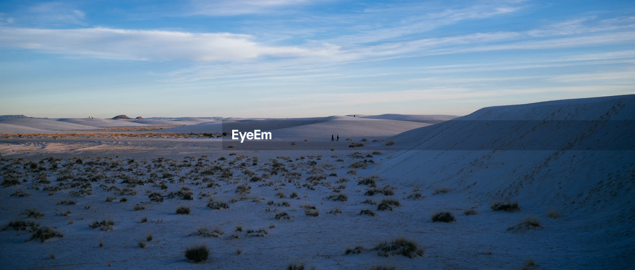 Scenic view of snow covered land against sky