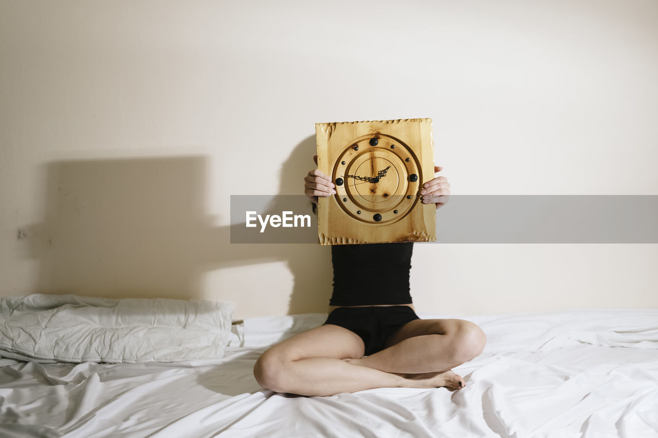 Woman hold clock and time