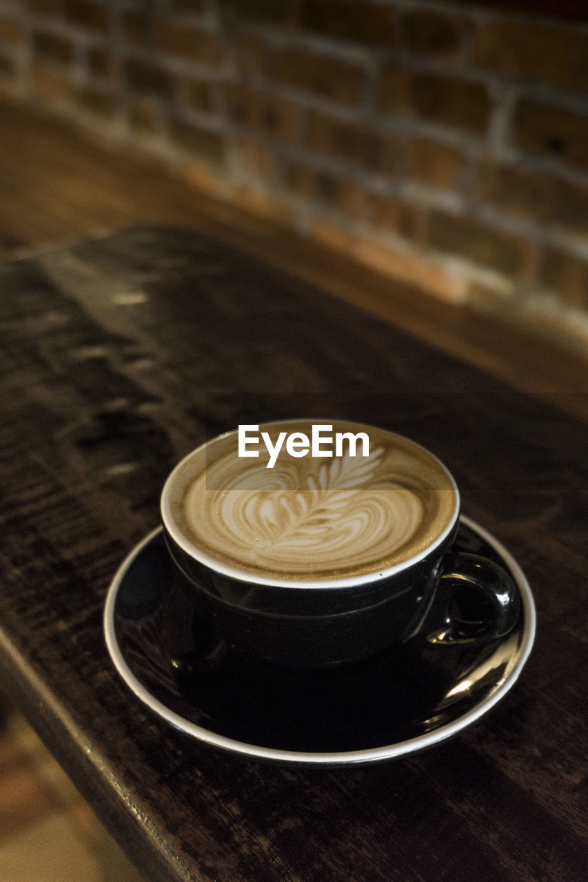 CLOSE-UP OF CAPPUCCINO ON TABLE