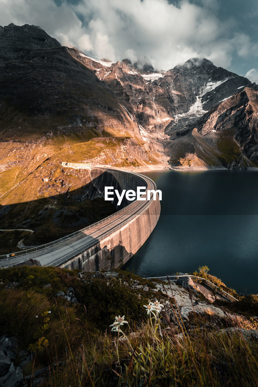 High angle view of dam by a mountain lake against a mountain