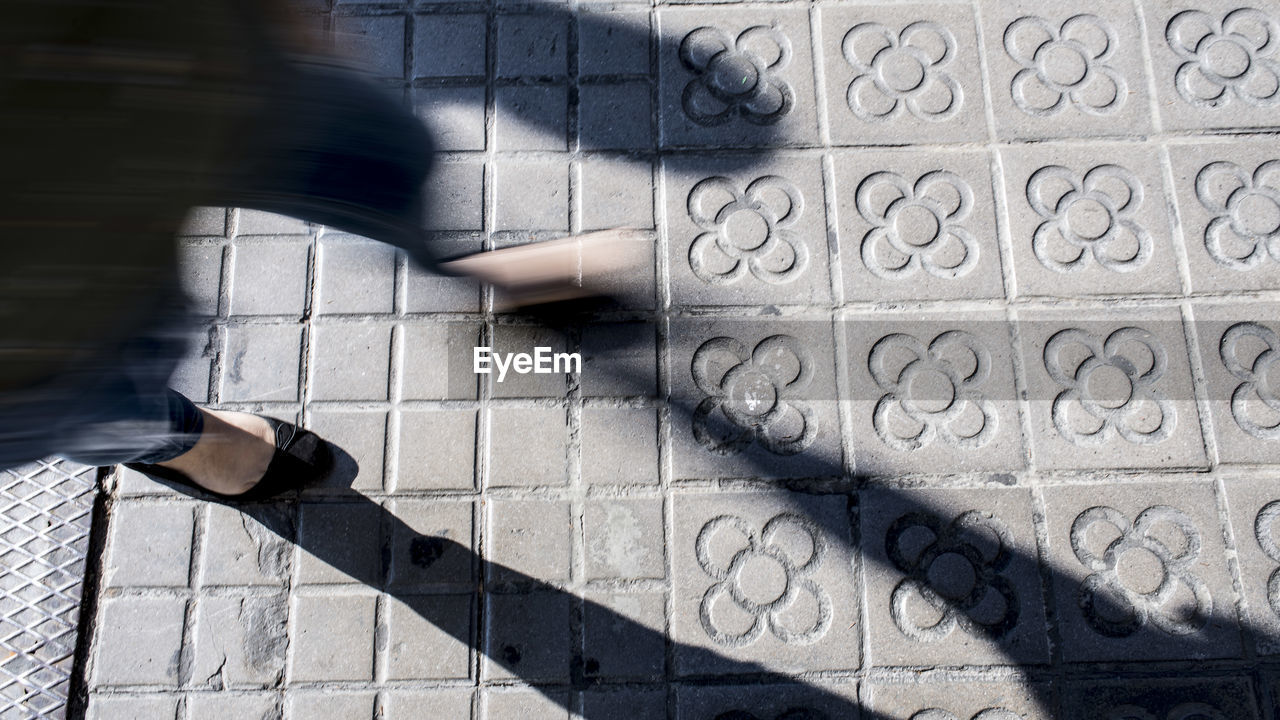 Low section of person walking on walkway