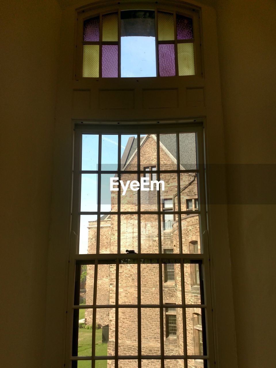 LOW ANGLE VIEW OF GLASS WINDOW OF BUILDING