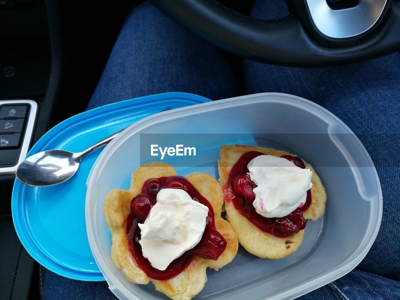 Midsection of person having sweet food in car