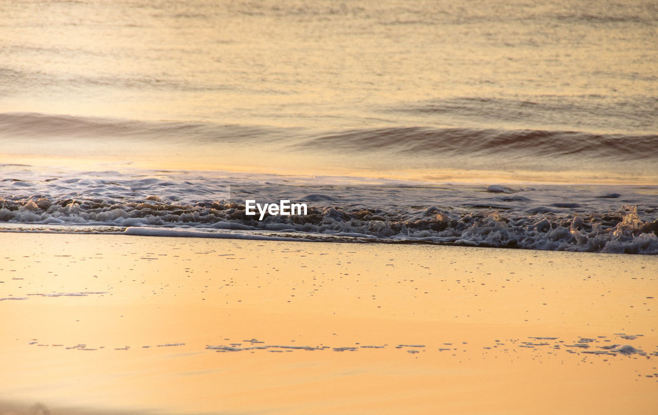 Scenic view of beach against sky during sunset