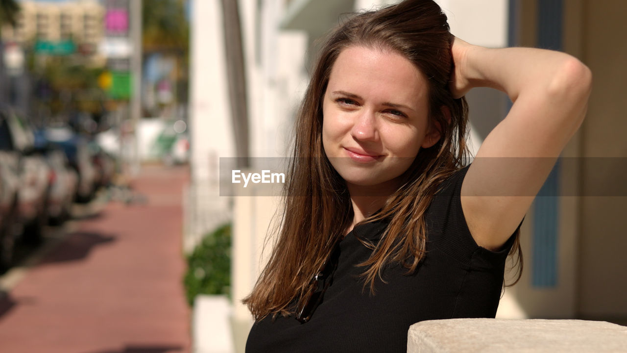 portrait of smiling young woman looking away