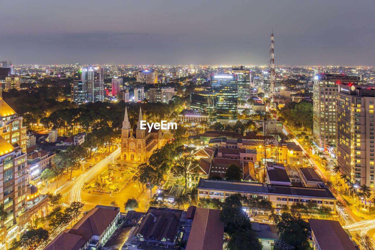 HIGH ANGLE VIEW OF ILLUMINATED CITY AT NIGHT