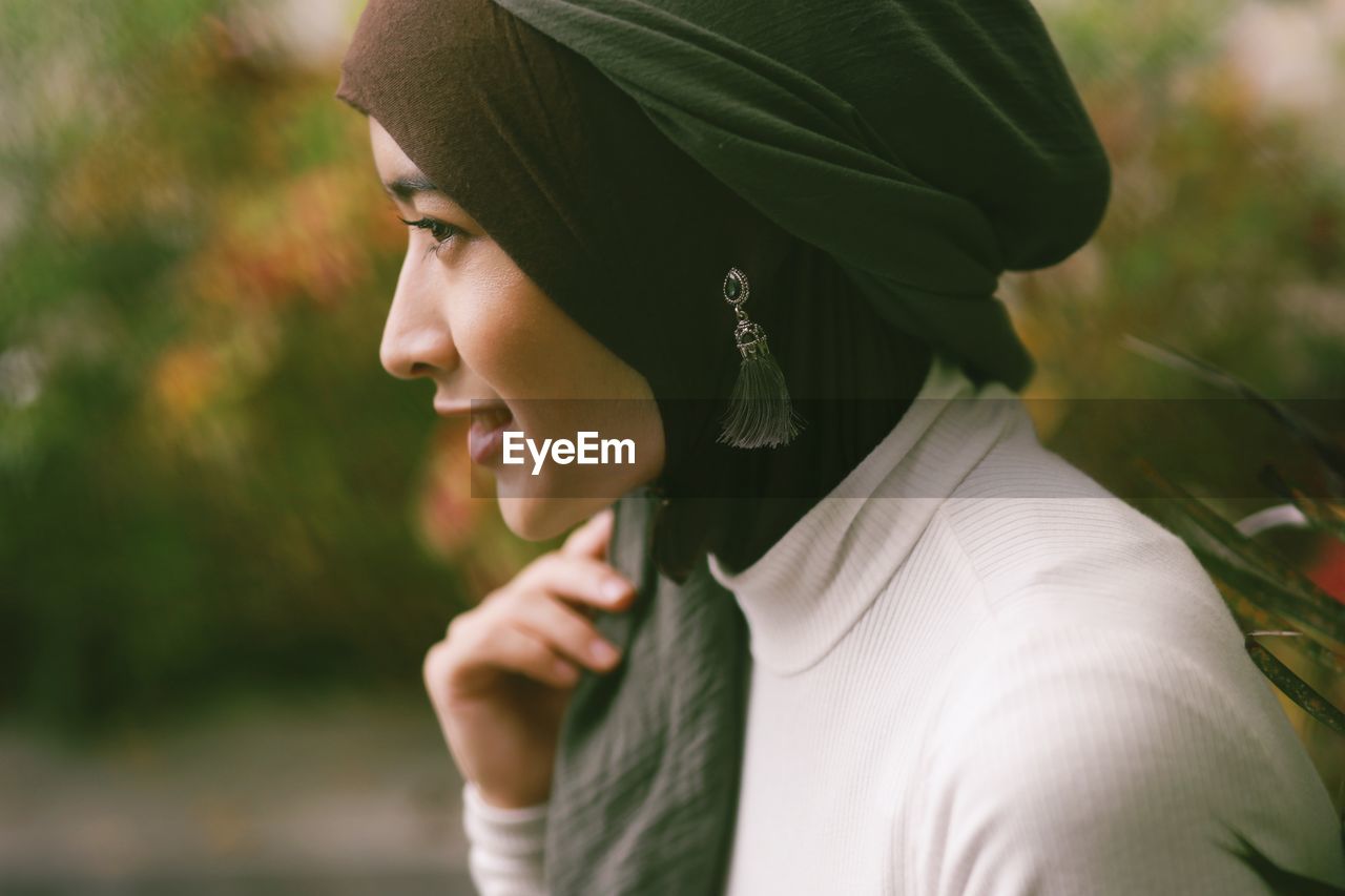 Close-up of smiling woman wearing hijab standing outdoors